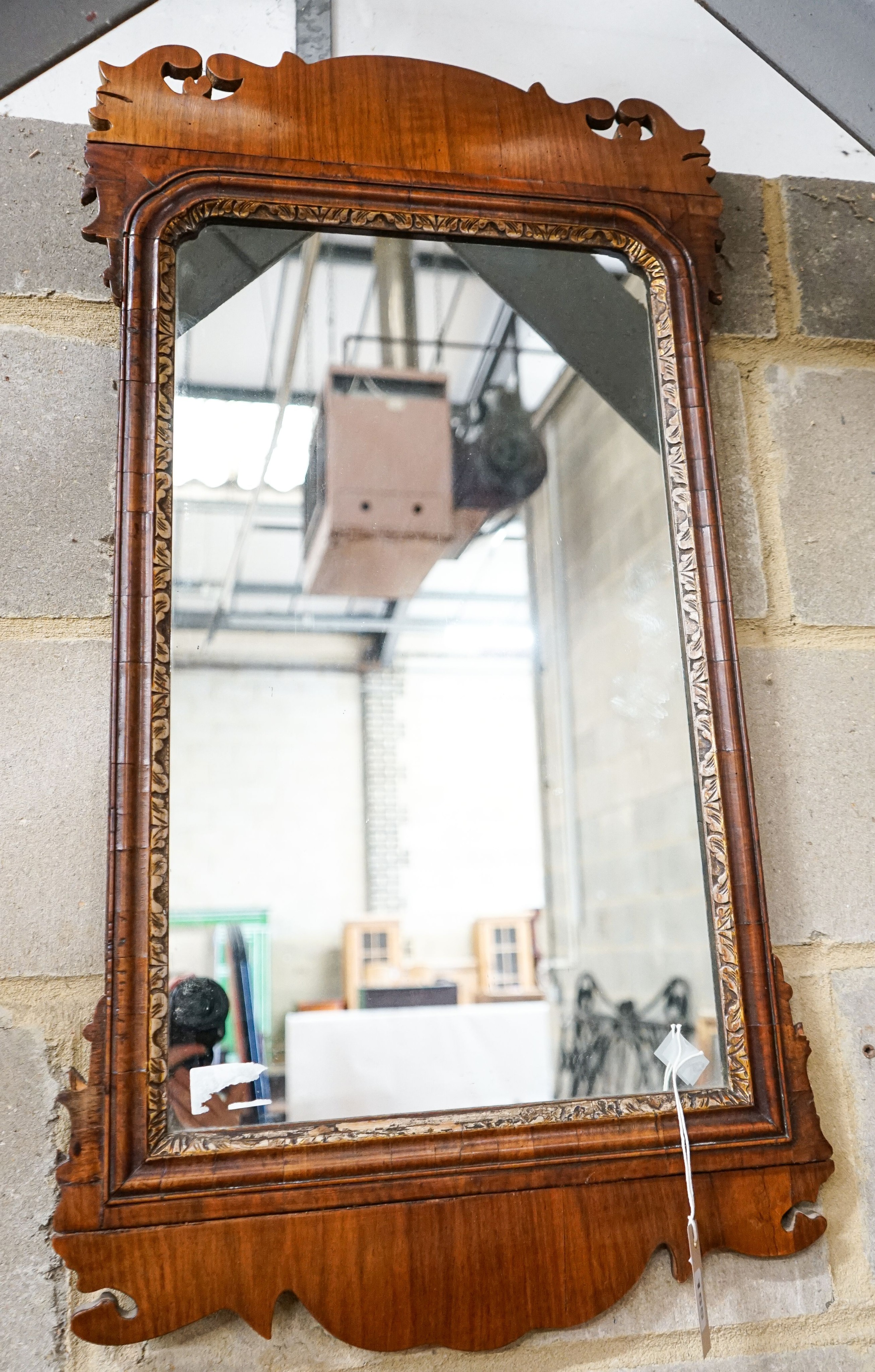 A George II walnut and parcel gilt fret cut wall mirror, width 46cm, height 88cm